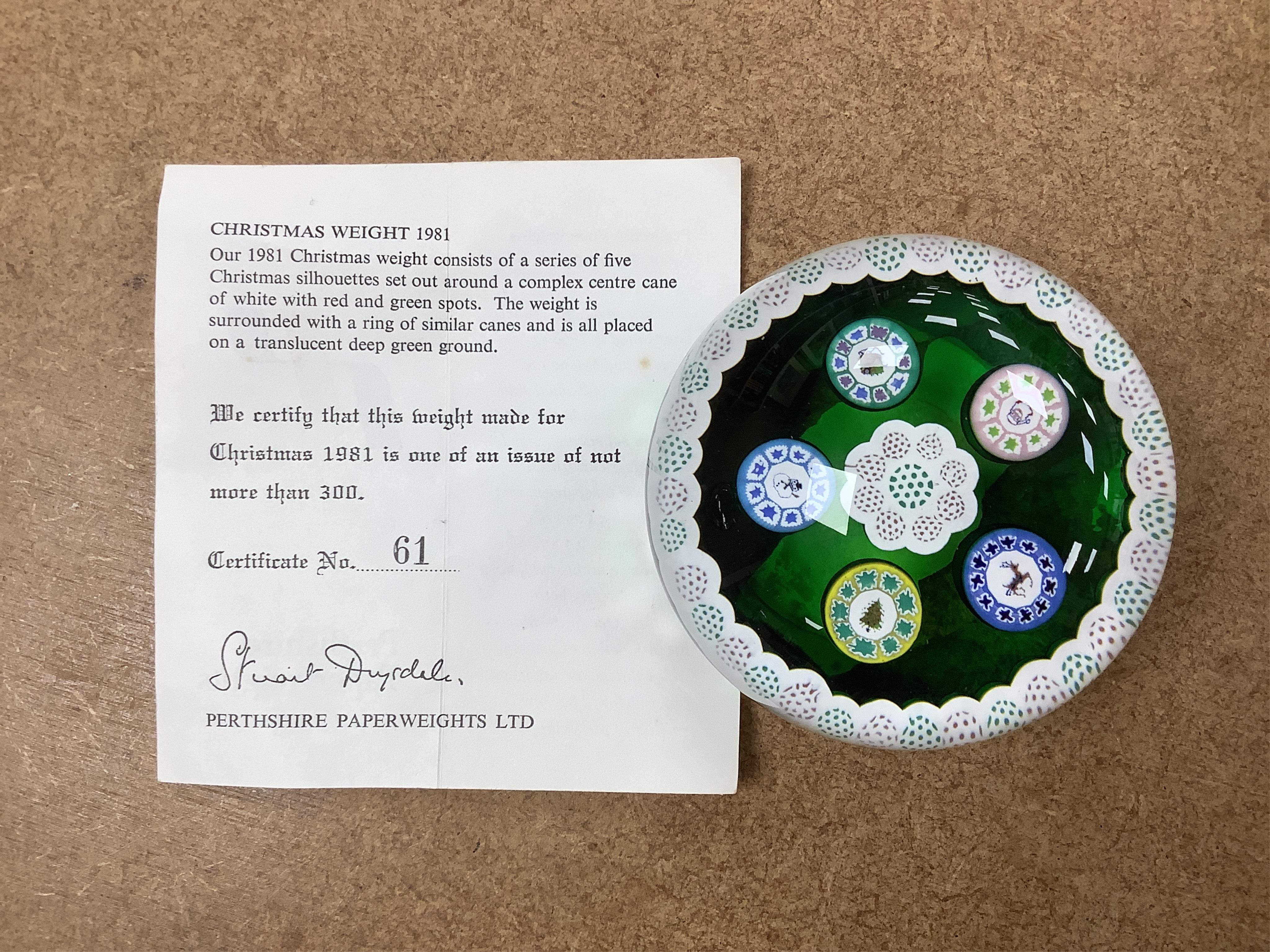 Two Perthshire glass Christmas paperweights for 1981 and 1983, a Perthshire miniature Latticino weight, 18/400, dated 1982, and a Selkirk glass Millefiori crown paperweight, 1982, (4) Largest Perthshire paperweight 8cm